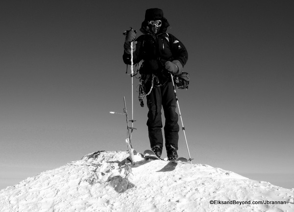 Skis on, pole on the USGS marker.