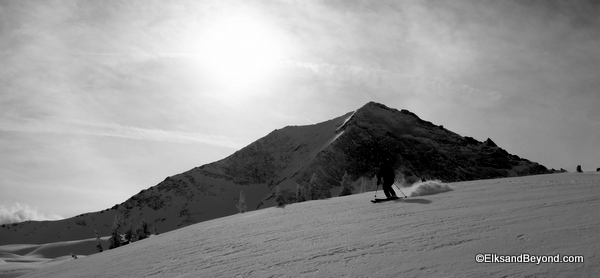 Dave skis with a rugged 13er in the background.