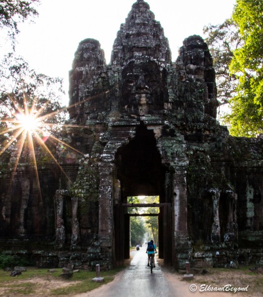 Elisabeth Pedaling through the victory gate of Angkor Thom.  