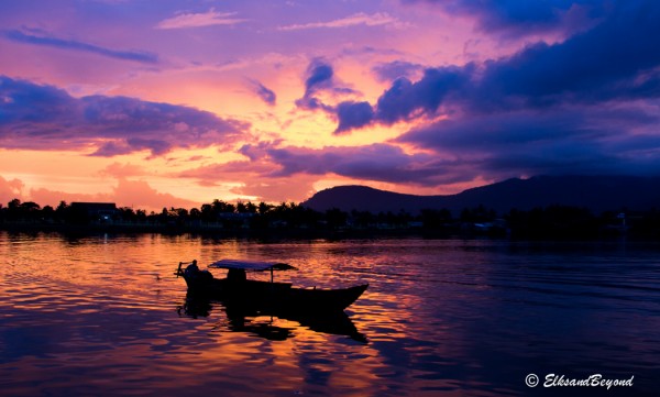 The sun sets as a river taxi comes in to drop off near downtown.