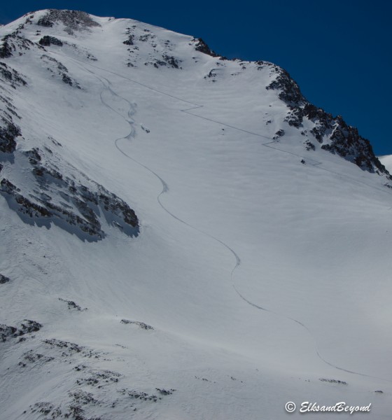 Colter making his way down fast smooth pow.